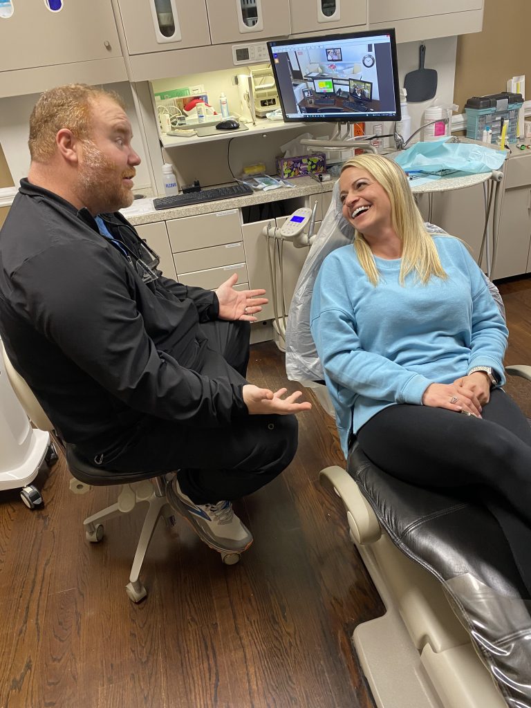 Dr. Yates talking with dental patient